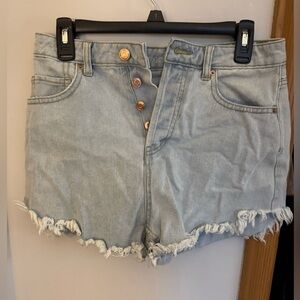 Blue denim jean shorts with ruffles.